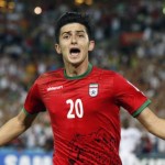 Iran's Sardar Azmoun celebrates his goal during their Asian Cup Group C soccer match against Qatar at the Stadium Australia in Sydney